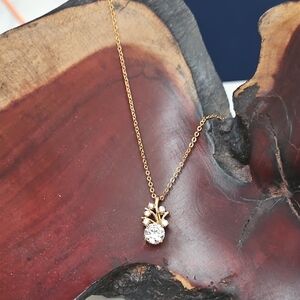 CZ abstract flower on a dainty 18" gold tone necklace.